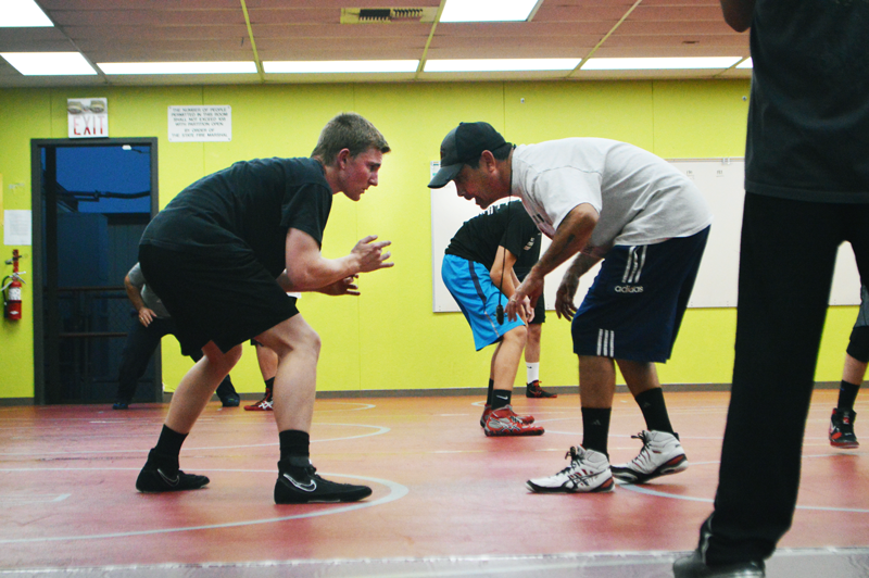 Zach Tener practices wrestling with a coach.
Photo by Hailey Juergenson