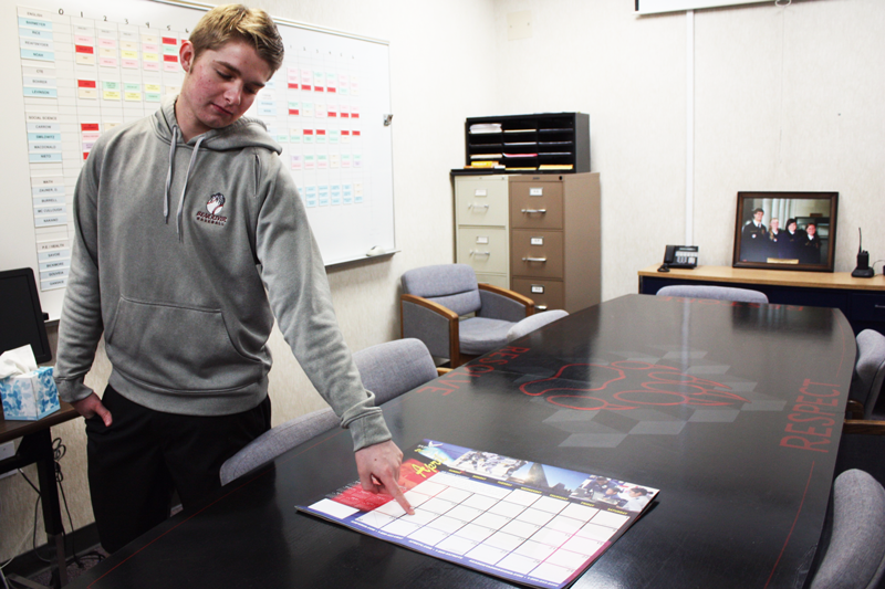Trevor Hennig, a senior, points to the day lost from spring break due to  the snow day.  Photo by Bella Batula 
