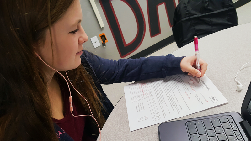 Kayla Toft, a junior, fills out a CSF application.  Photo by Bella Batula
