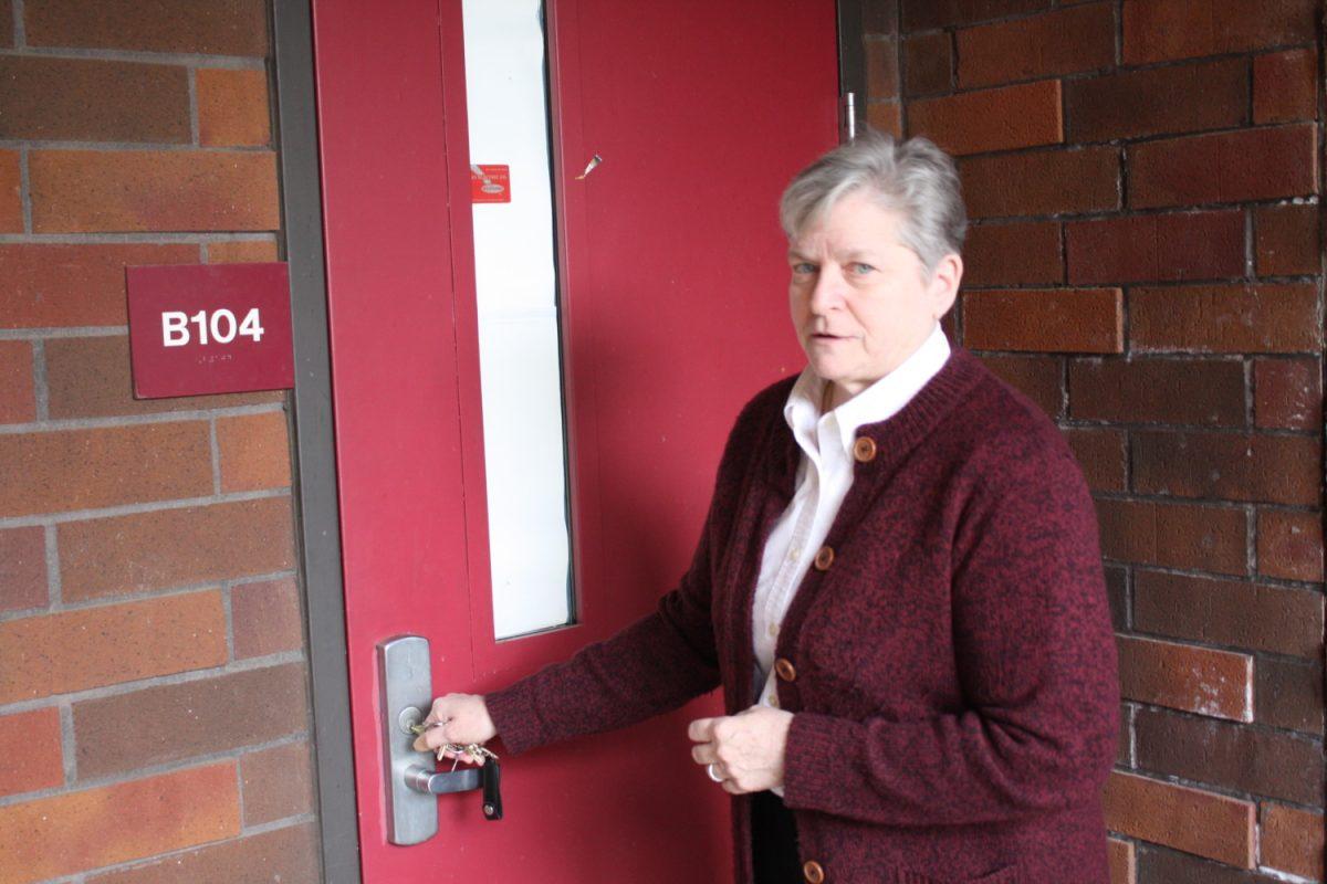 Vice Principal Cathy Peterson demonstrates the locking mechanism used during the shelter in place procedure.  Photo by Brandon McGinnis 