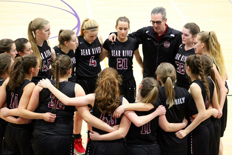 The Girls Varsity Basketball Team huddles before a Playoff game against Foothill High School. Photo by Tina Toft
