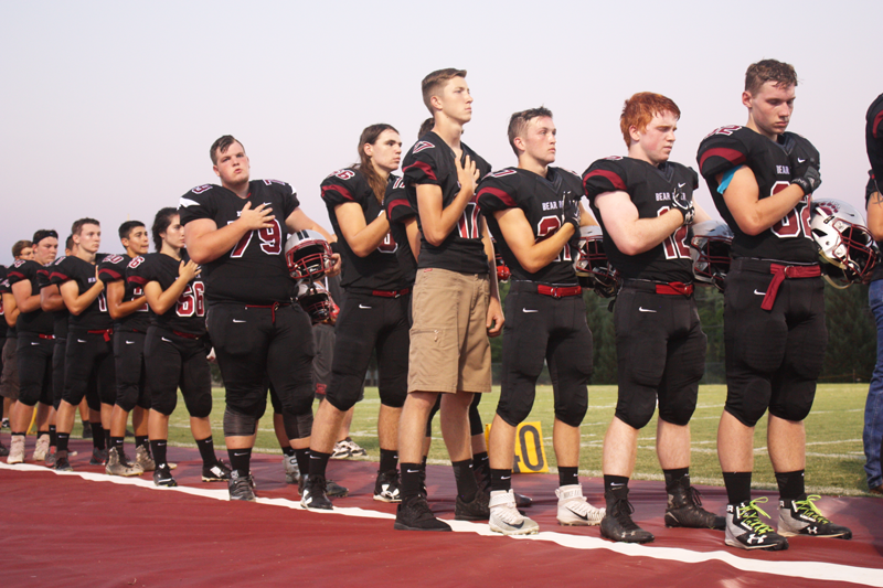 The Varsity Football Team listens to the Nation Anthem at Bear Rivers first home game against Orland. Photo by Hailey Juergenson
