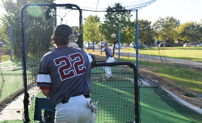 Junior Nathan Van Patten pitches to Senior Johnny Calleri in the batting cage. Photo by Josh Howser