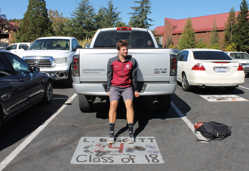 Senior Luke Baggett leans against his truck, which is parked on his personalized parking space. Baggett was one of five students whose parking spaces were vandalized. Photo by Massiel Chavez