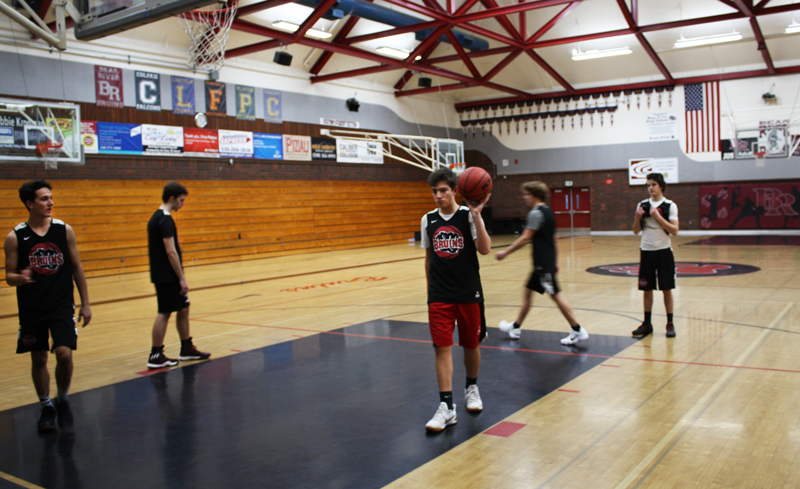 Varsity Basketball player Justin Powell, a sophomore, practices in the gym. Photo by McKenna Hisaw