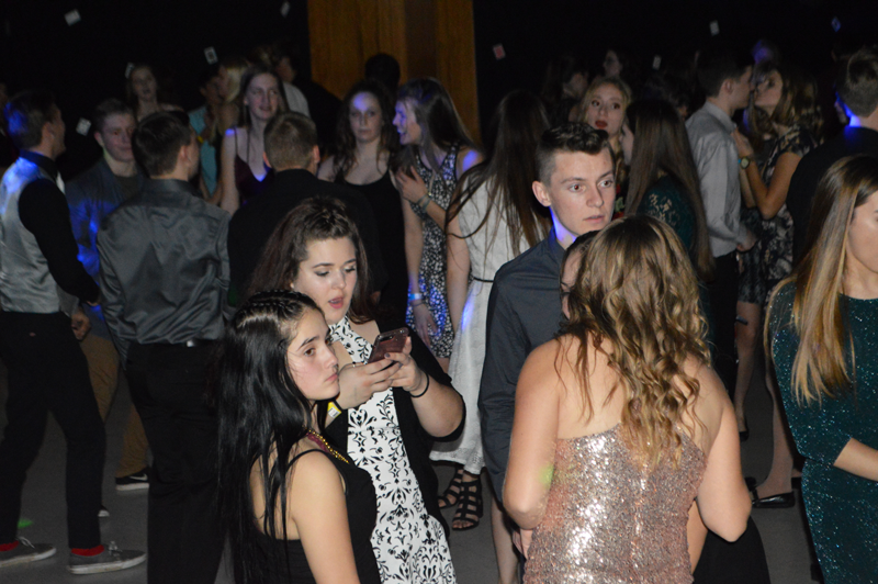 Nevada Union Sophomore Olivia Bohrer, Senior Kaylee Bohrer, and Sophomore Alex Bohn hang out at the House of Cards Homecoming Dance. Photo by Jakob Berger