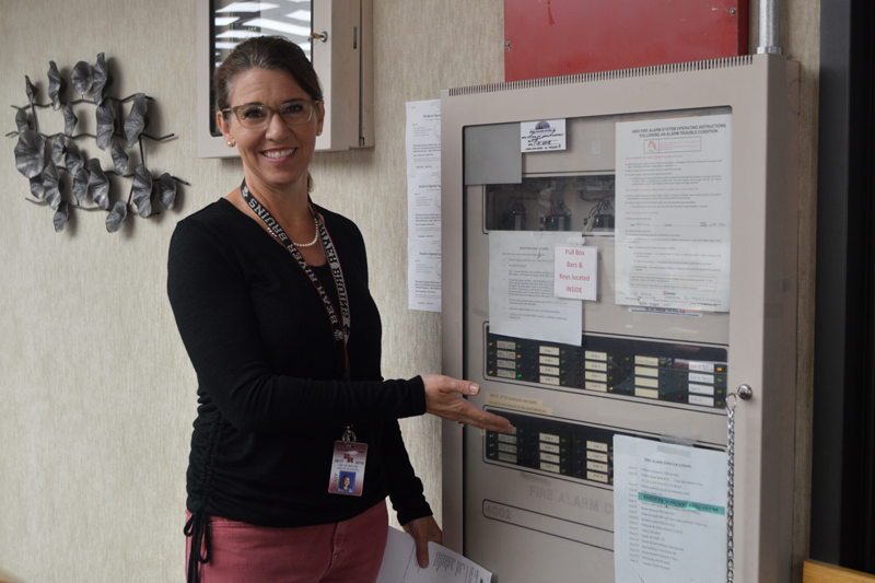 School Site Technician Stephanie OCallaghan shows the control board where the alarms are controlled. Photo by Kalei Owen