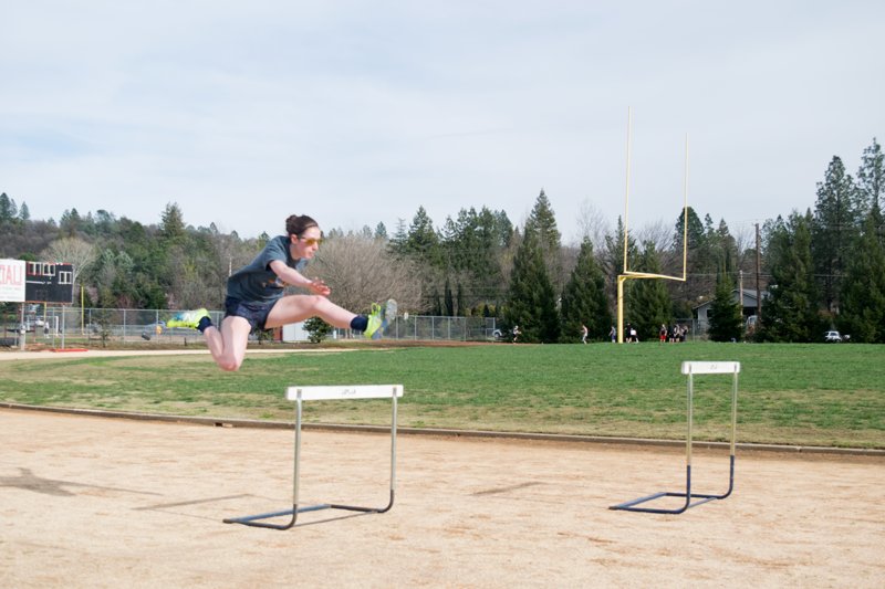 Sophomore Grace Billingsley jumps a hurdle. Photo by Morgan Ham