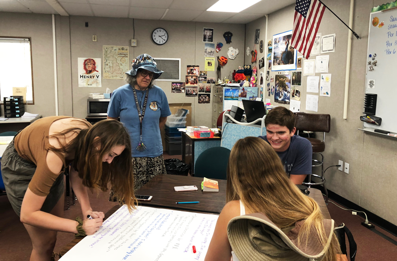 English Teacher Sara Noah, pictured with her students, says summer homework is a good way to demonstrate Bruin Grit. Photo by Morgan Ham