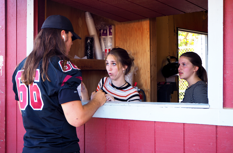 Senior Trae Nix talks to Sophomore Lexi Templeton and Freshman Alison Whiting at the FFA Cookhouse. Photo by Kalei Owen