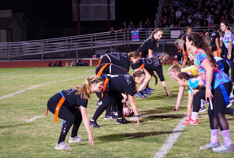Junior Jenna LaPlante takes a three-point stance as the Juniors and Seniors face off at the Powder Puff game. Photo by Zach Fink