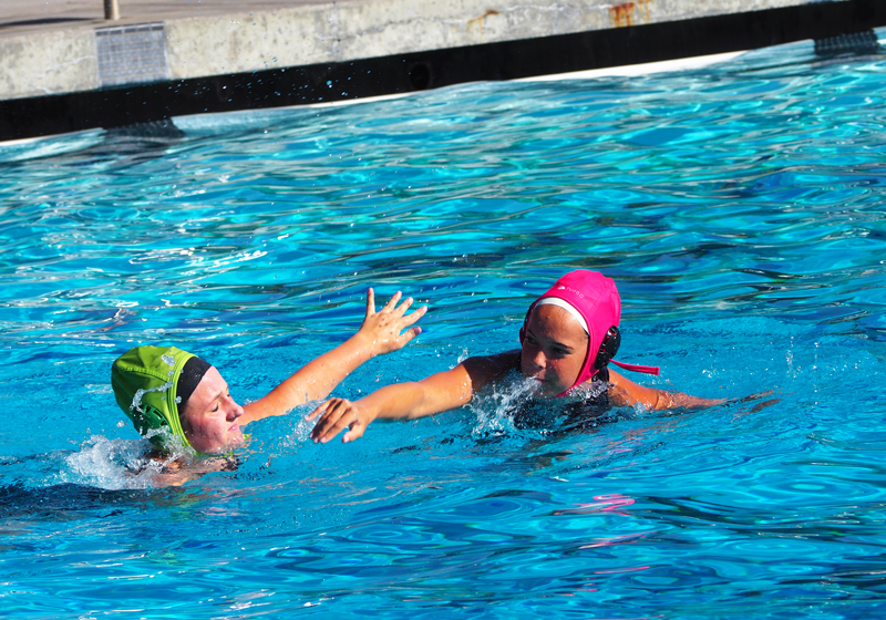 Junior+Whitney+Lybbert+and+Sophomore+Emma+Cutter+participate+in+a+Varsity+Water+Polo+practice.+Photo+by+Maddie+Meilinger