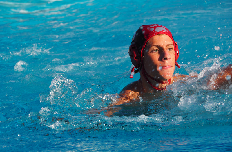 Jett Livingston, a junior on the JV Boys Waterpolo team, focuses on the game.  Photo by Maddie Meilinger 
