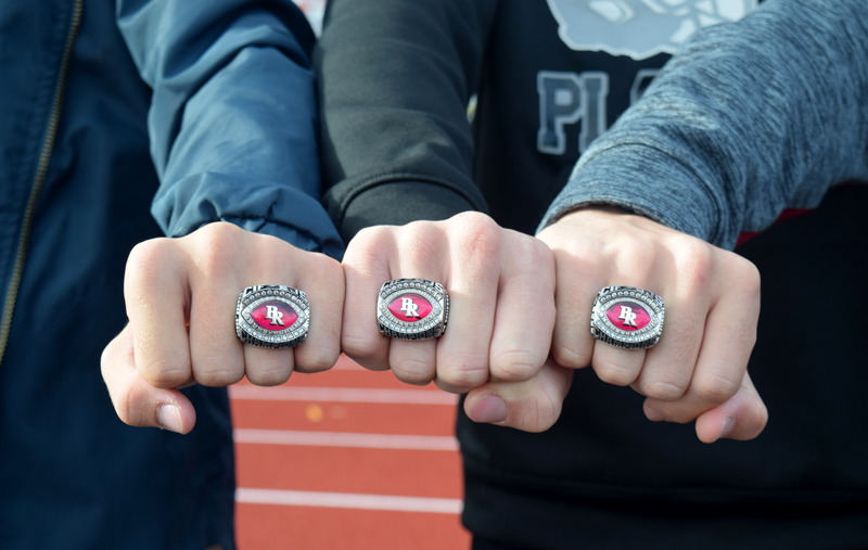 Colton+Jenkins%2C+Tre+Maronic%2C+and+Dylan+Scott+show+off+last+years+playoff+rings.+Photo+by+Kalei+Owen