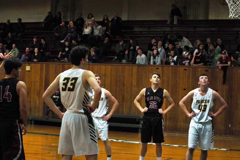 Sophomore Jace Rath on the Varsity Basketball team waits for a free throw. Photo by Kalei Owen