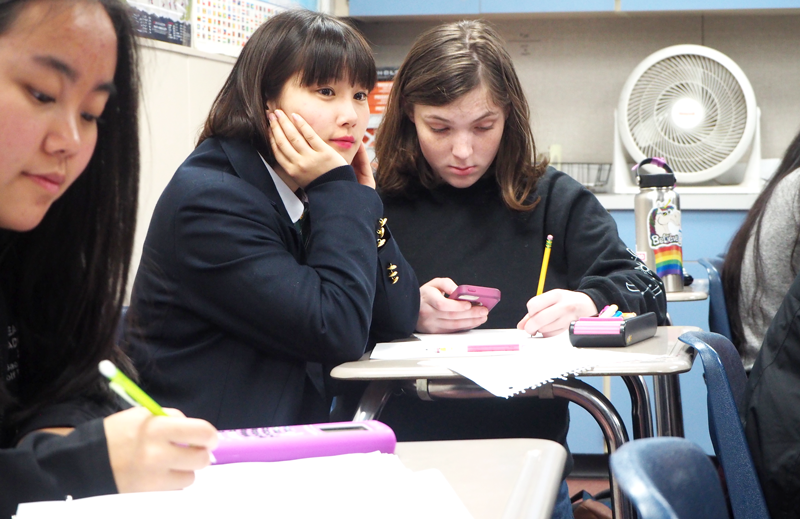 Host student Junior Catherine Desplancke sits in class with Japanese exchange student Nanami.  Photo by Zach Fink. 