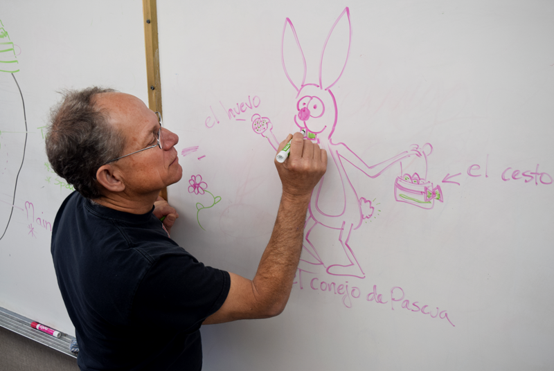 Spanish Teacher Daniel Bussinger labels a drawing of the Easter Bunny with Spanish words.  Photo by Kalei Owen. 