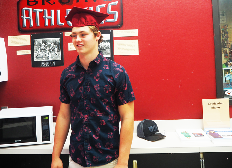 Senior Austin Slining poses for a picture in his graduation cap. Photo by Martin Foster. 