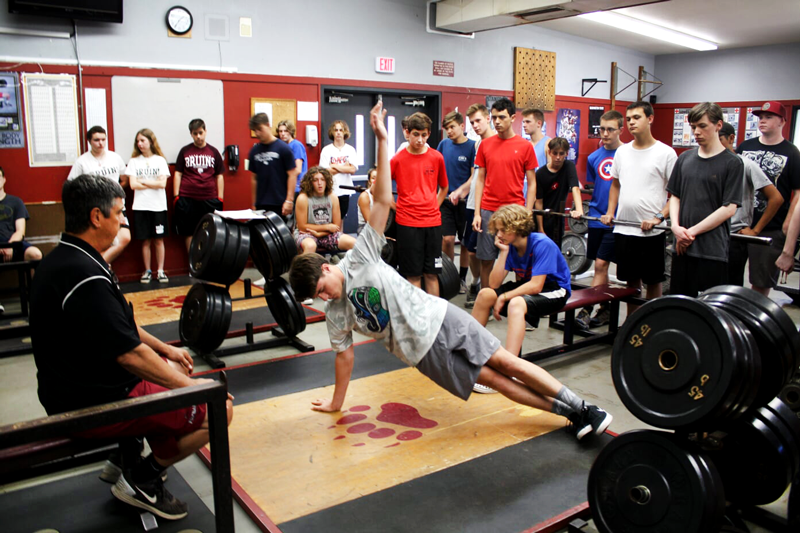 Senior Sean Cullers demonstrates a long arm plank for the Weights class. Photo by Dylan Walters