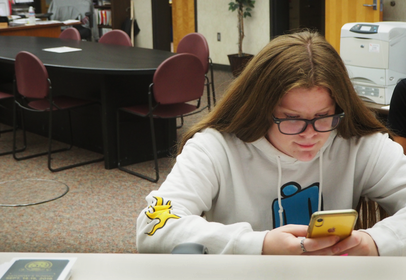 Senior River Jarman uses her phone, something that often causes students to procrastinate on their work.  Photo by Maddie Meilinger   