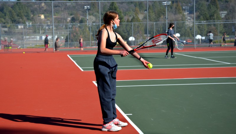 Freshman Olivia Herr practices tennis at Bear River on March 25. Photo by Maya Bussinger