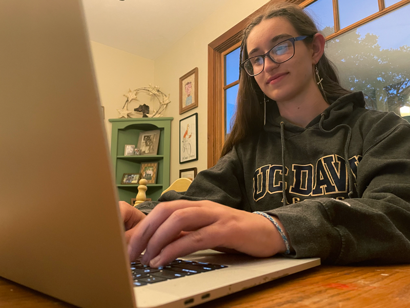 Bear River alumna Sonora Slater, a graduate of the Class of 20, is hard at work on her laptop. Photo by Jamey Slater