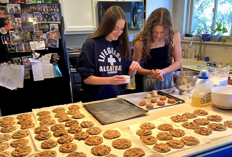 Gabby Gerster and Claire McDaniel hard at work making cookies for Bruins.  Photo by Monica Meszaros