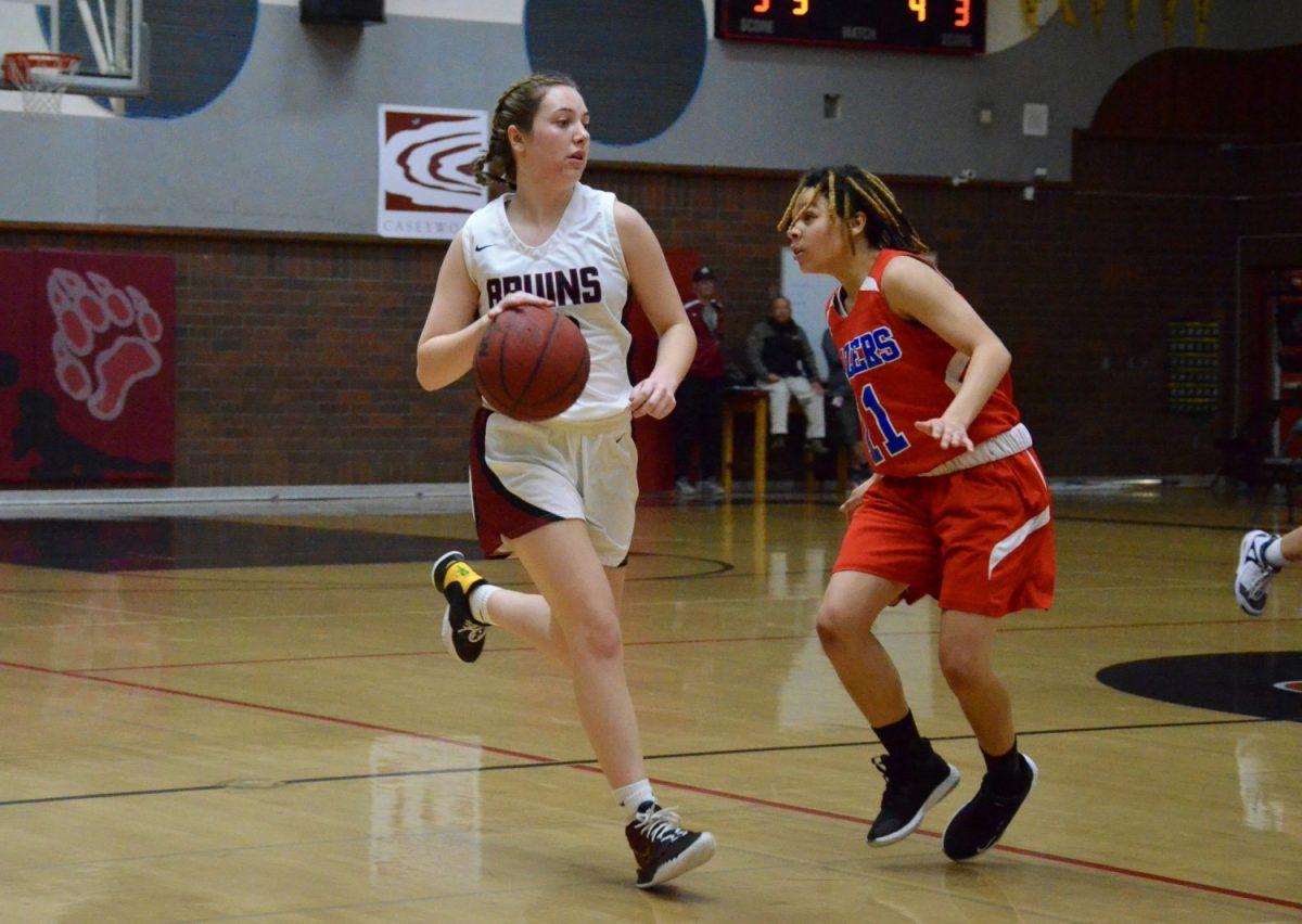 Junior Cass Craig dribbles up the court during the teams game against Lindhurst. Photo by Maya Bussinger
