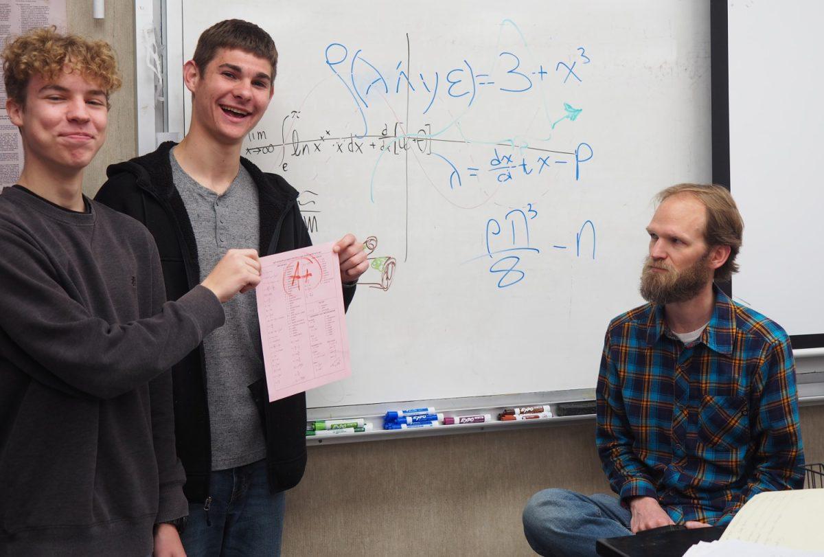 James Haworth, left, and Eli Funk cant believe their luck — they passed an AP Calculus test! Teacher Peter Gammelgard is none too pleased. Photo by Olivia Herr