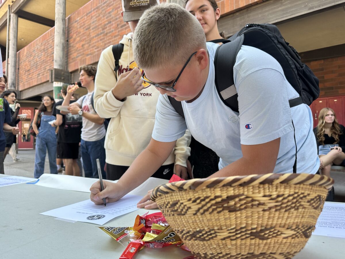 Freshman Austin Cloyd signs up for Key Club during Club Rush on Sept. 20.