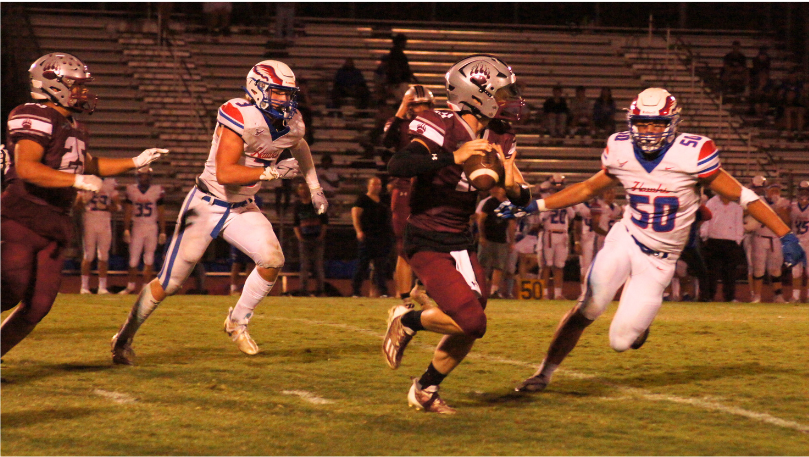 Cole Stowers (11) rolls out of the pocket in search of an open receiver.