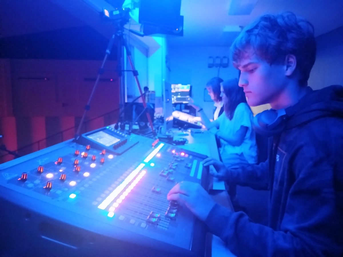 From right, Seth Strong, Ella Miller  and Jaylen Hale in the booth controlling lights and sound for a show.