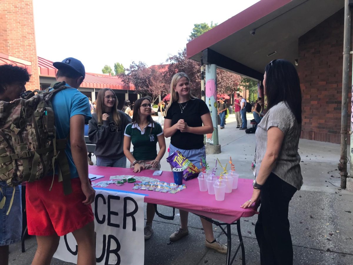 Jessica Lee talking to soccer club members at Club Rush.