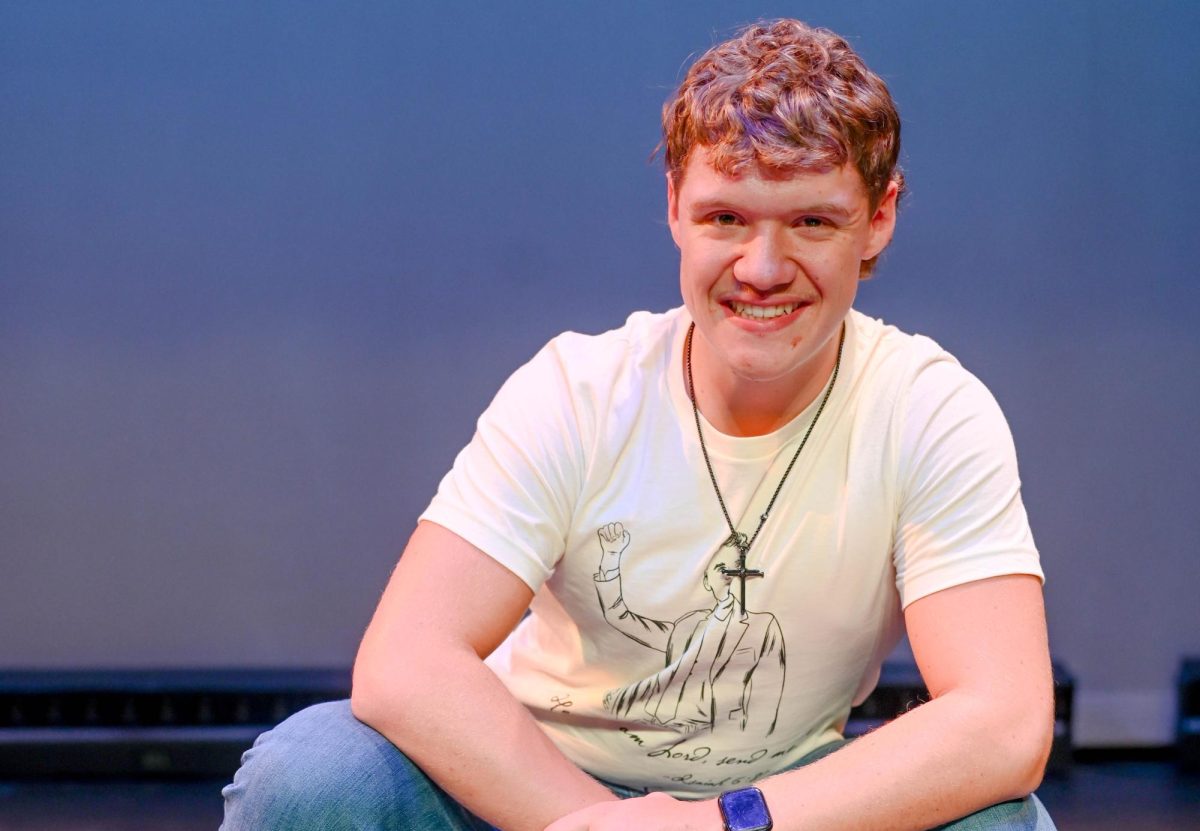 Troy Chapman posing on stage in theater '