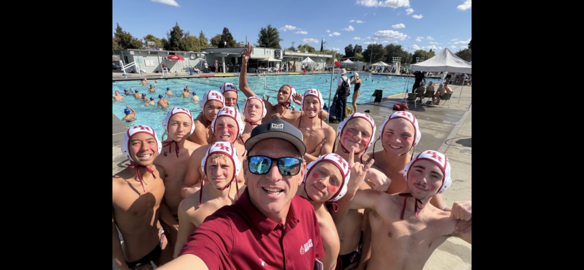 Photo of Jonathon Thornley and his Varsity Water Polo Team. Jonathan is to the left of the coach one person and the third from the front. 